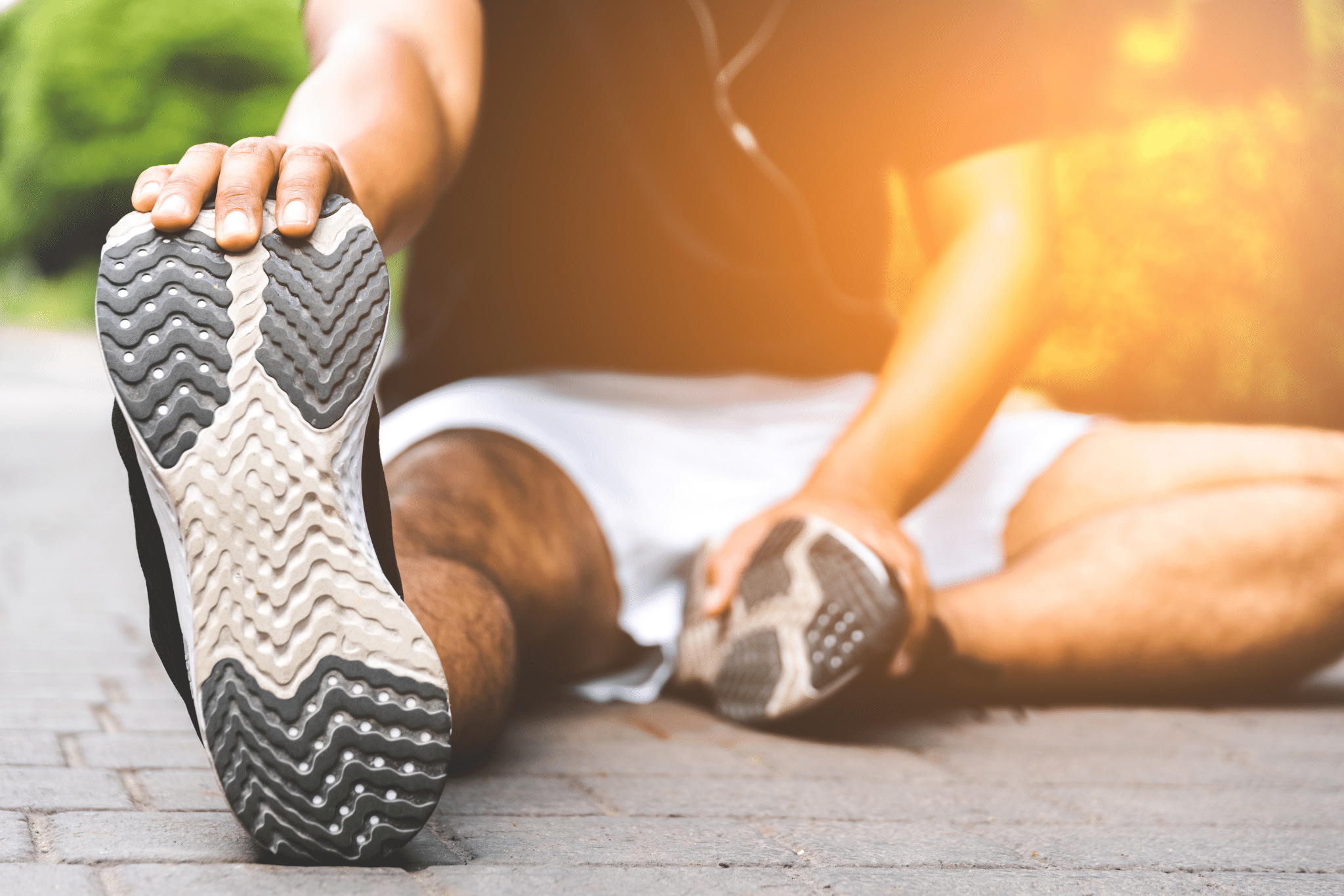 Young fitness man runner stretching before run with copy space healthy lifestyle and sport concepts